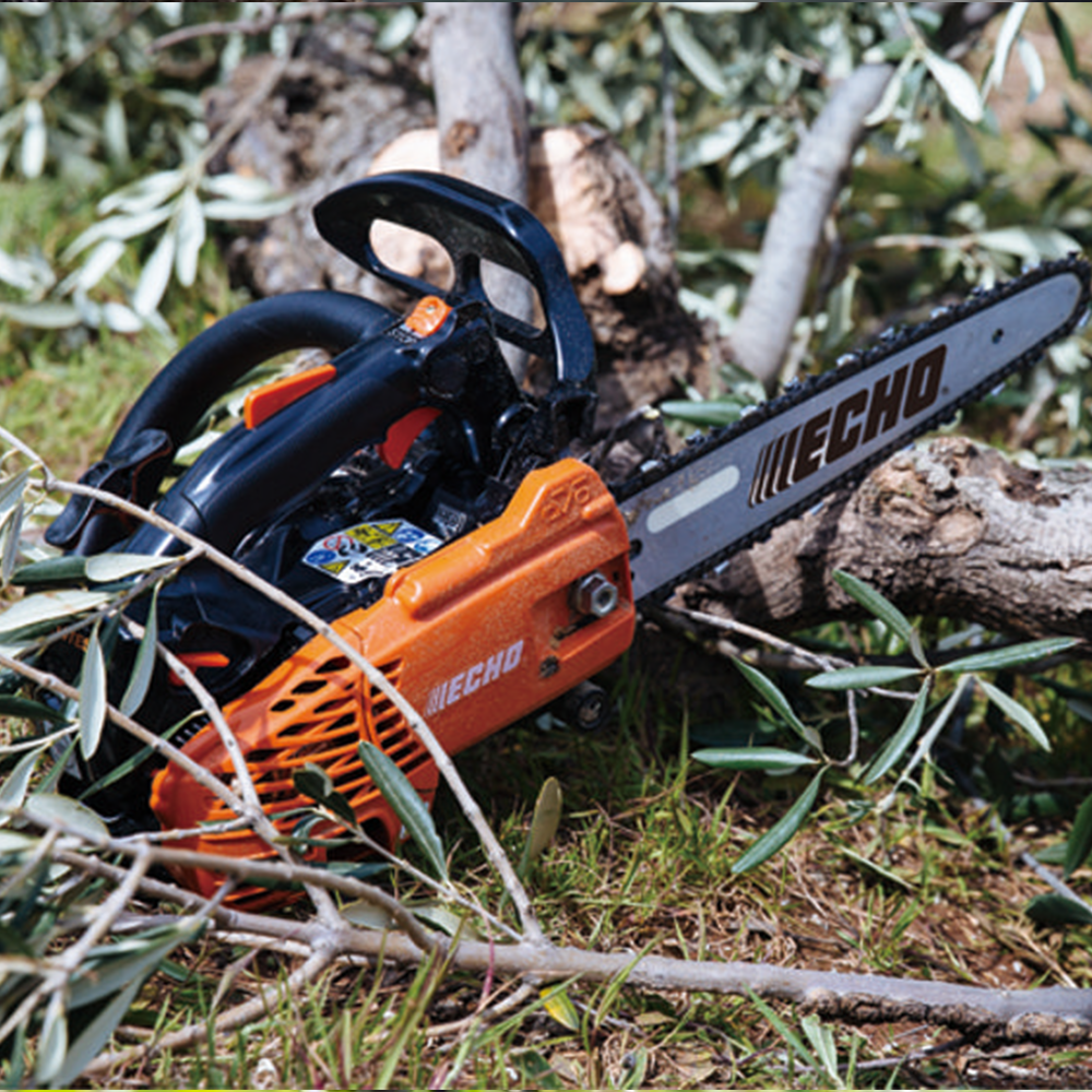 10e4cdtub14.png - Mowers Online Echo chainsaw on ground near logs