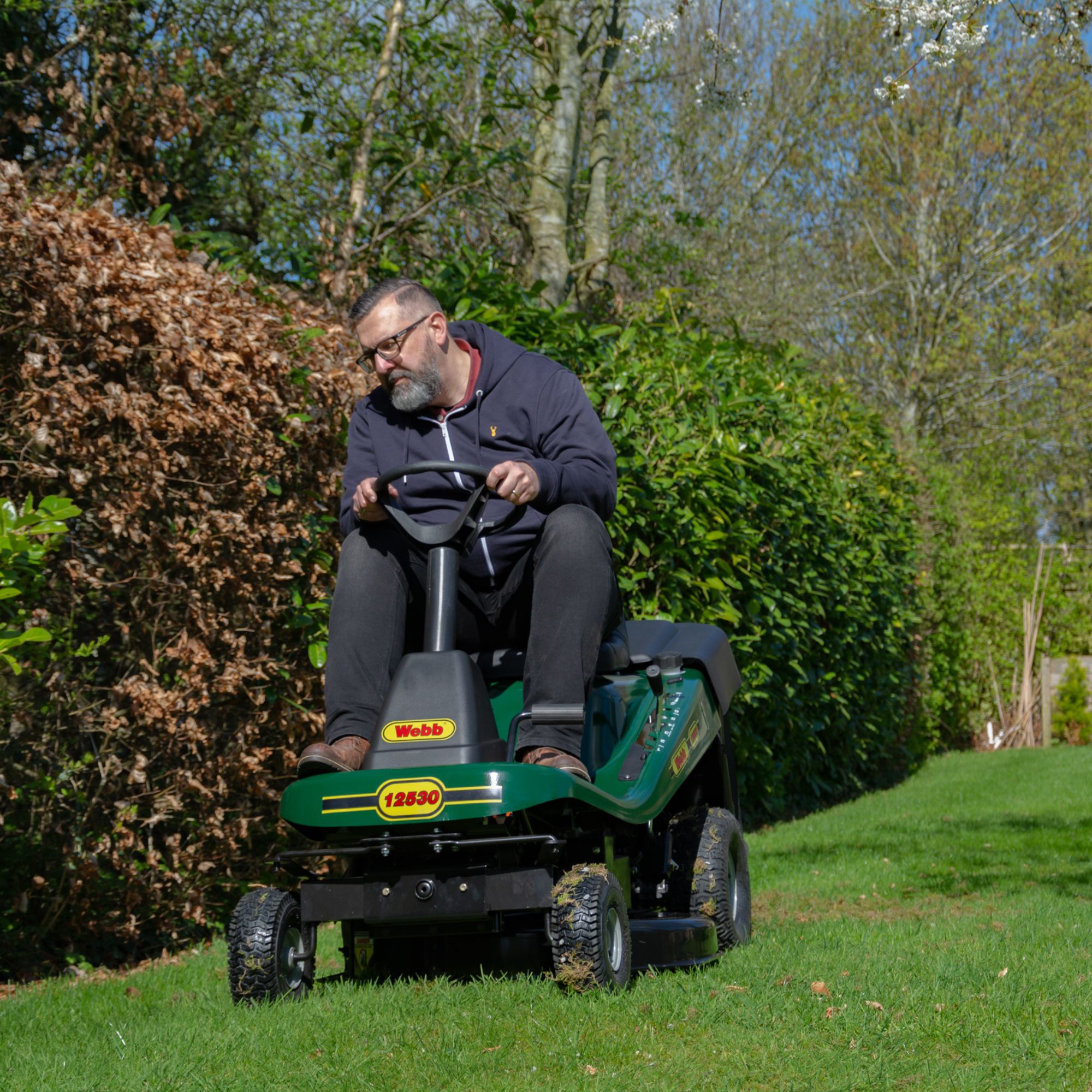cgbxyoa4iyg.jpg - Mowers Online Man operating riding lawn mower in garden