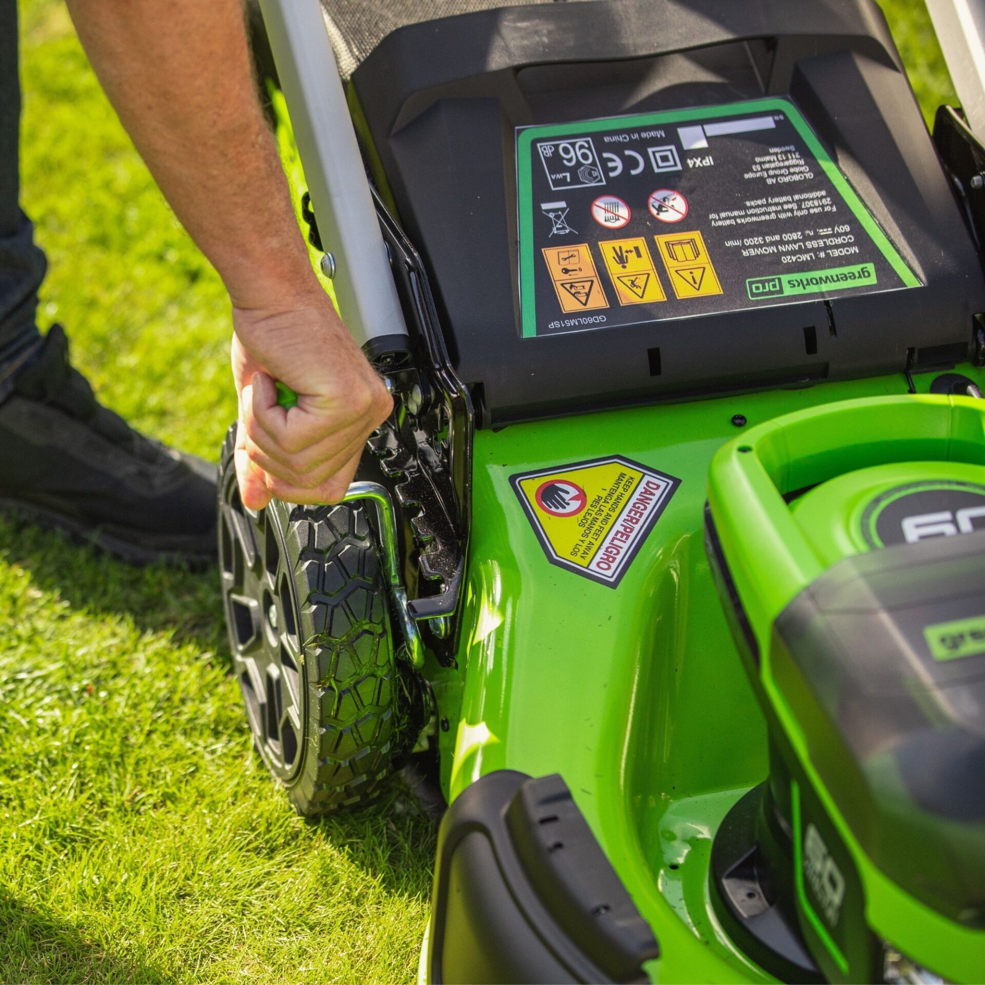 ql0iyfxe20k.jpg - Mowers Online Person operating green lawn mower on grass
